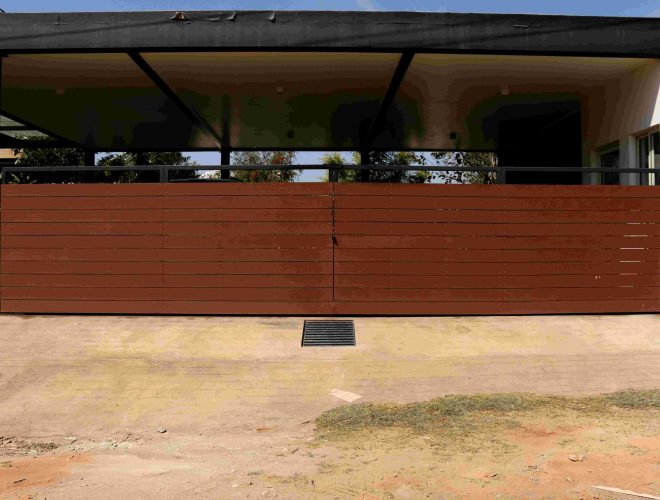 Stylish wood-finish WPC gate for modern, durable home exteriors.