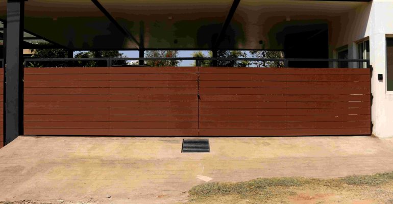 Stylish wood-finish WPC gate for modern, durable home exteriors.