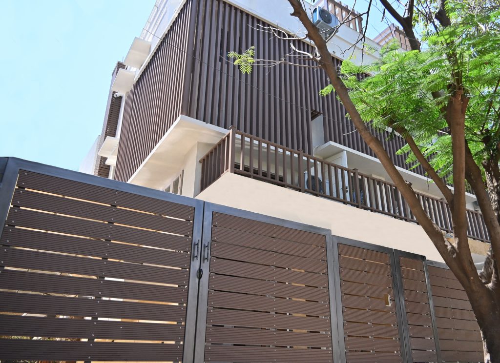Designer gates and railings with modern vertical cladding on a building.