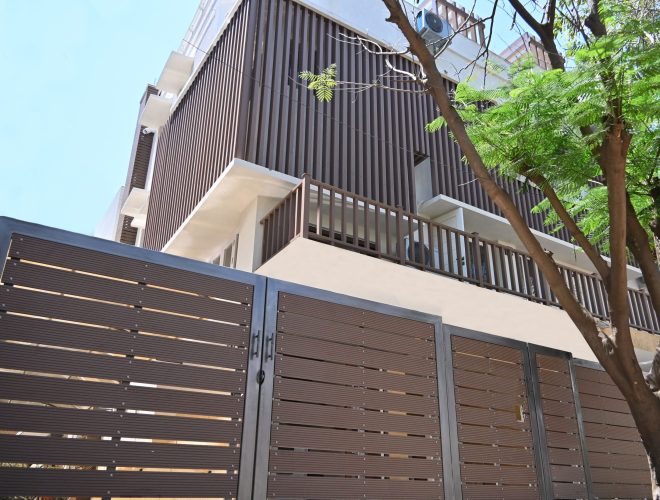 Designer gates and railings with modern vertical cladding on a building.