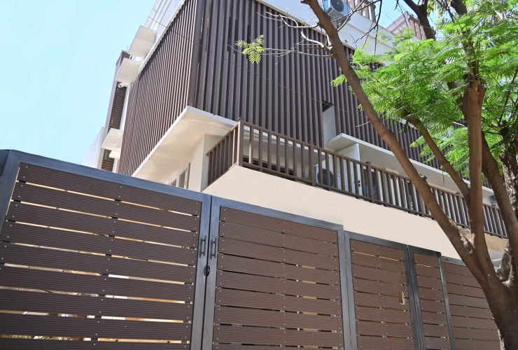 Designer gates and railings with modern vertical cladding on a building.