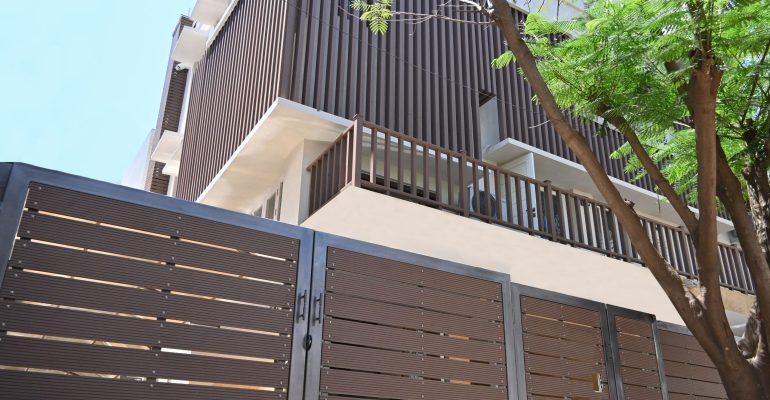 Designer gates and railings with modern vertical cladding on a building.