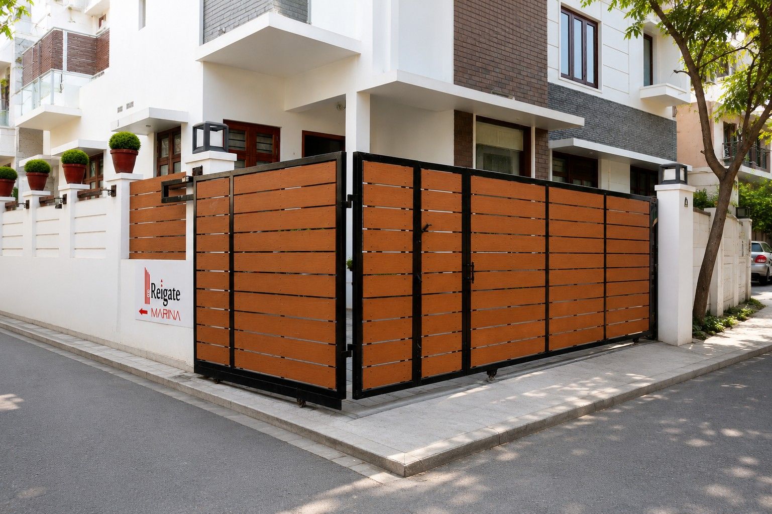 DealerDistributo - Versaplank Gated wooden entrance to a modern residential building with a sign reading 'Reigate Marina' nearby.