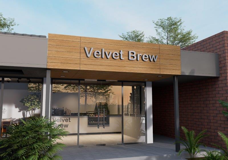 Velvet Brew storefront with a wooden sign and glass doors, exterior plants framing the entrance.